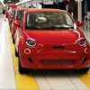 Row of red Fiat 500e EVs on a factory floor