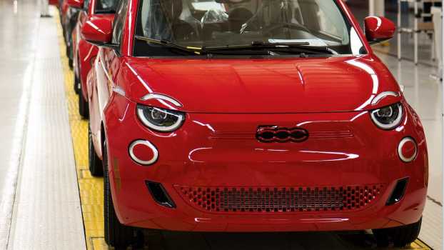 Row of red Fiat 500e EVs on a factory floor