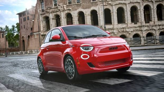 2024 Fiat 500e driving on a street in Italy.