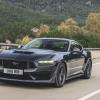A 2024 Ford Mustang Dark Horse flashes a UK plate on British roads.