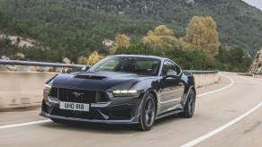 A 2024 Ford Mustang Dark Horse flashes a UK plate on British roads.