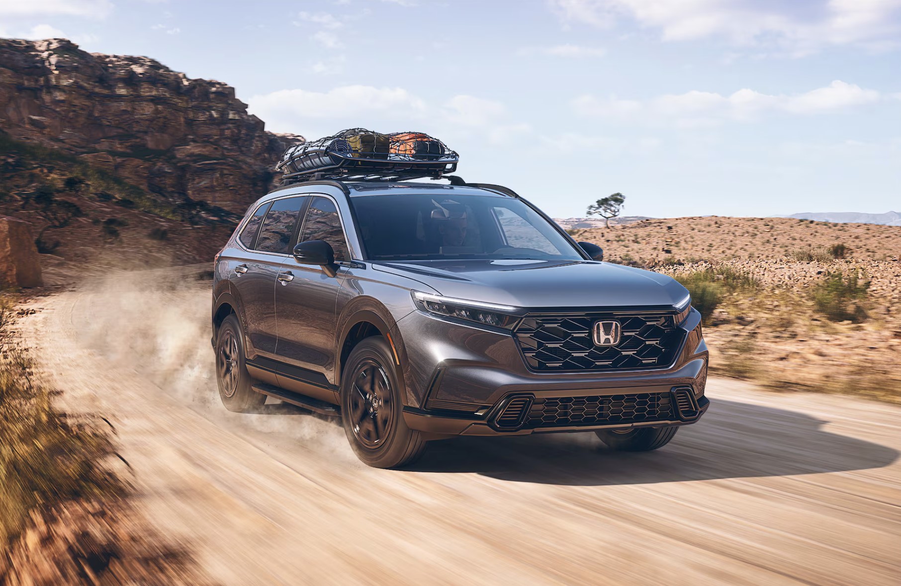 The 2024 Honda CR-V driving on a dirt road