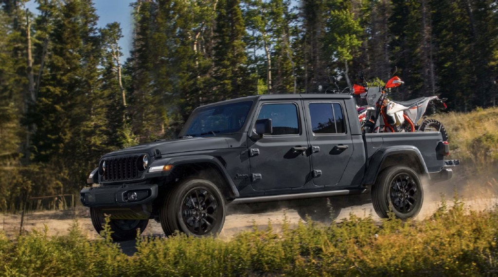 The 2024 Jeep Gladiator NightHawk with a dirtbike in the bed 