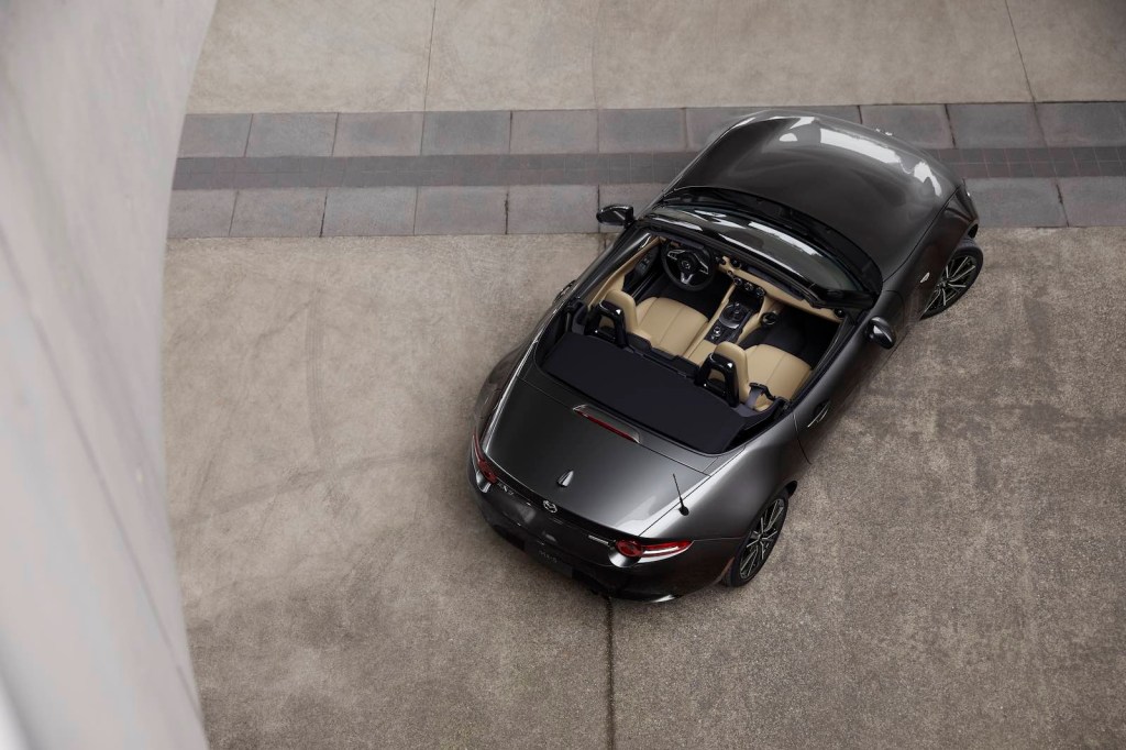 Overhead view of a Mazda Miata roadster with its top down.