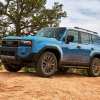 Blue 2024 Toyota Land Cruiser on a dirt trail.