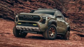 The 2024 Toyota Tacoma Hybrid climbing over rocks