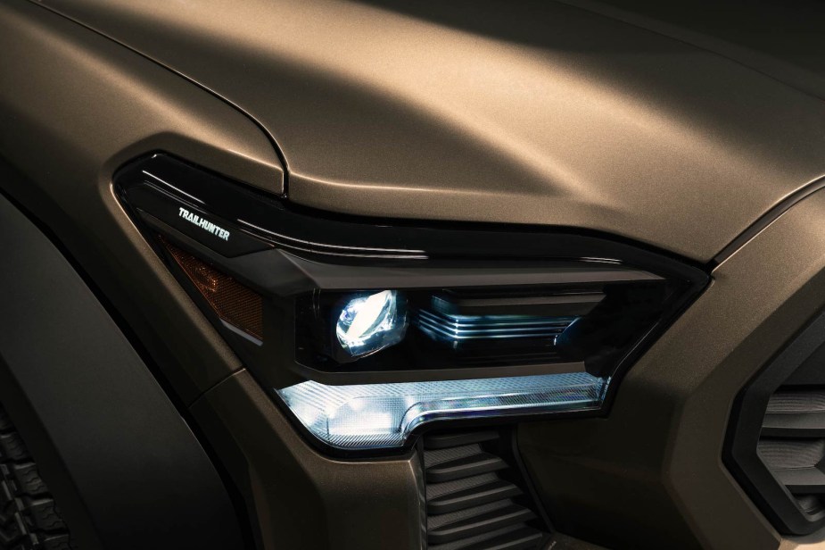 Close up of the Trailhunter logo in the headlight of a new Tacoma pickup truck