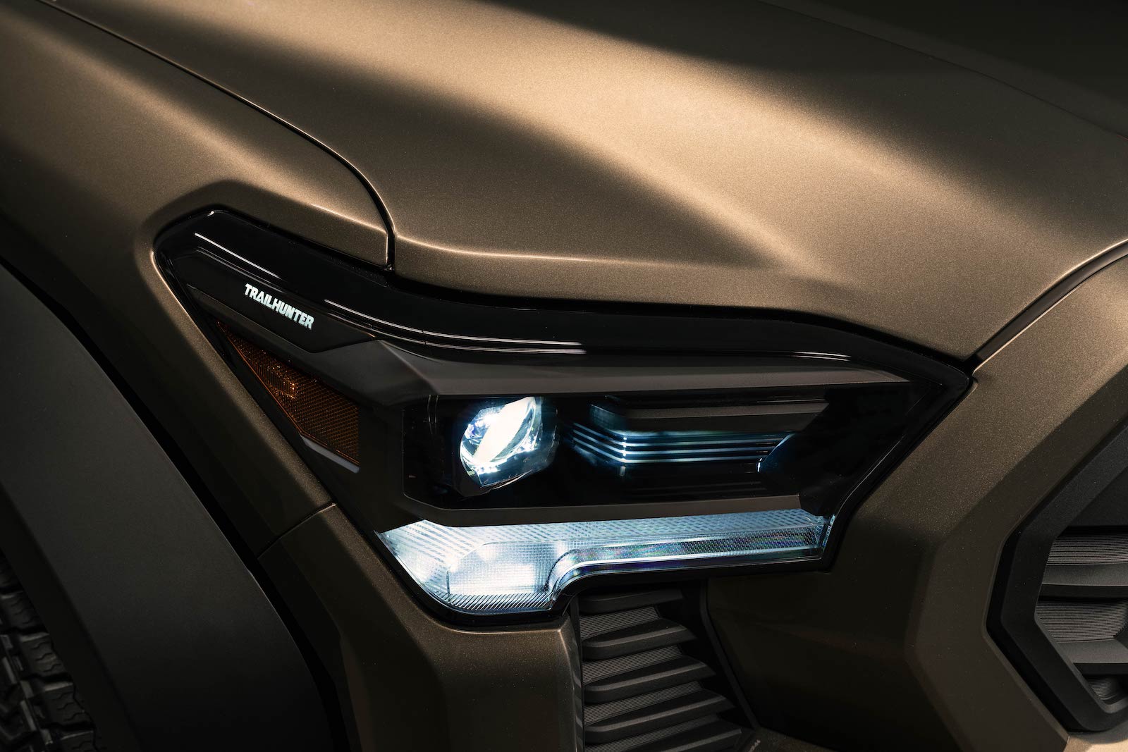 Close up of the Trailhunter logo in the headlight of a new Tacoma pickup truck