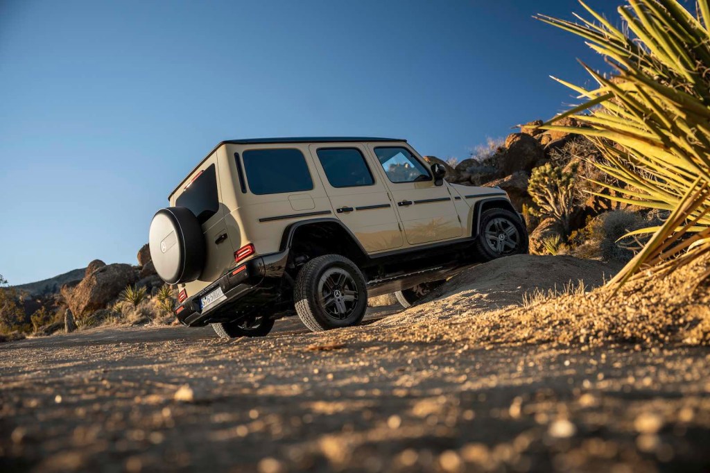 electric Mercedes G Wagon climbing an obstacle off road