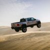 Off-road Ram 1500 RHO truck jumping over sand dunes