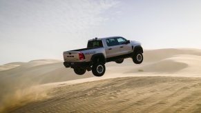 Off-road Ram 1500 RHO truck jumping over sand dunes
