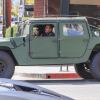 arnold schwarzenegger driving his vintage Hummer H1 SUV through downtown Los Angeles