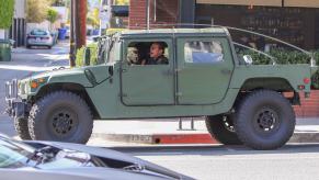 arnold schwarzenegger driving his vintage Hummer H1 SUV through downtown Los Angeles