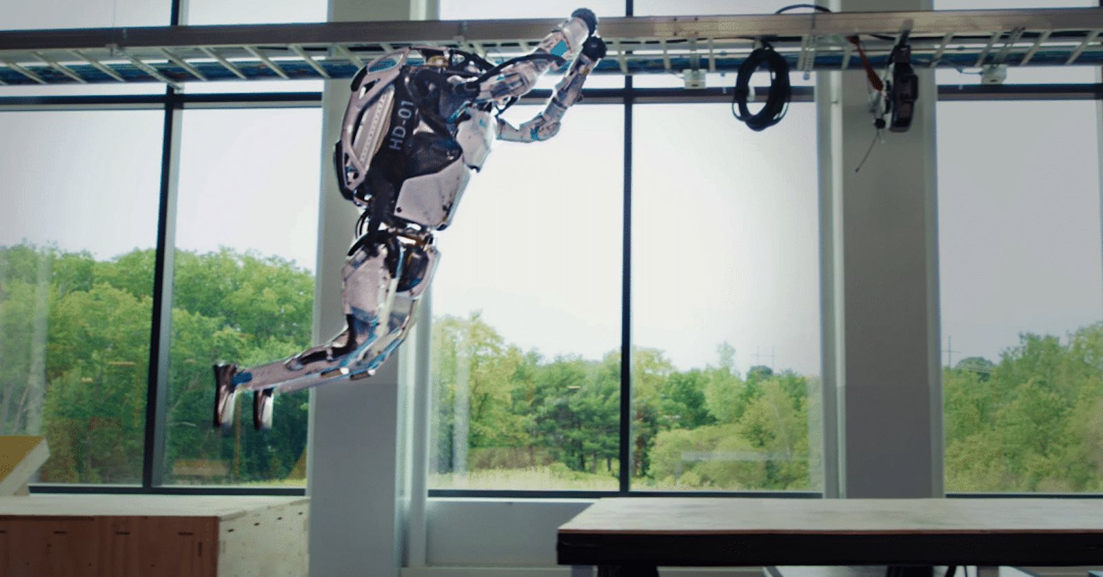 Humanoid Boston Dynamics robot jumping from one platform to another.