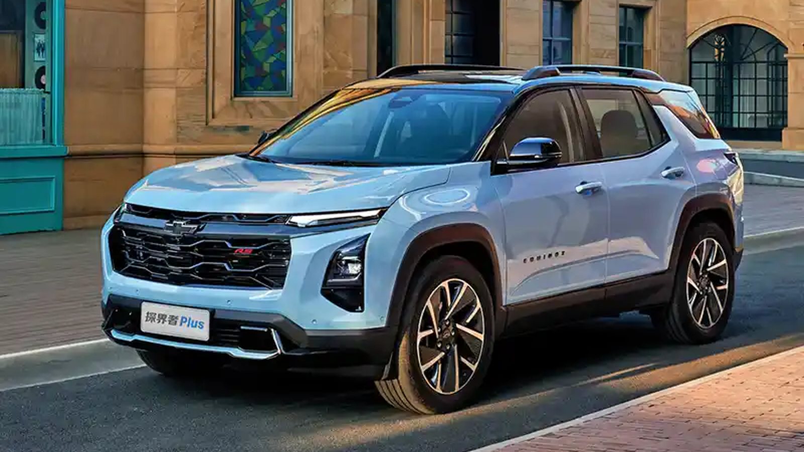Chevrolet Equinox Plus PHEV SUV driving on a city street.