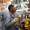 A Detroit factory worker assembling a Chevrolet Malibu