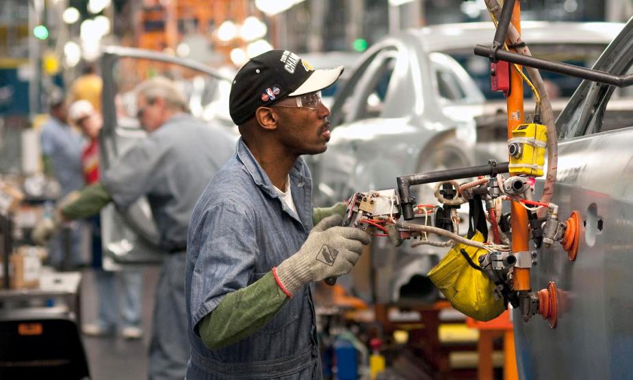 A Detroit factory worker assembling a Chevrolet Malibu