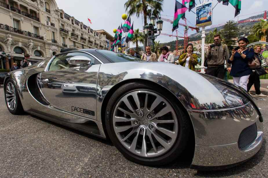 The fender of a chrome-covered Bugatti supercar parked on the streets of Monaco