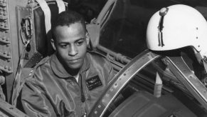 Black and white photo of test pilot Ed Dwight sitting in the cockpit of a plane