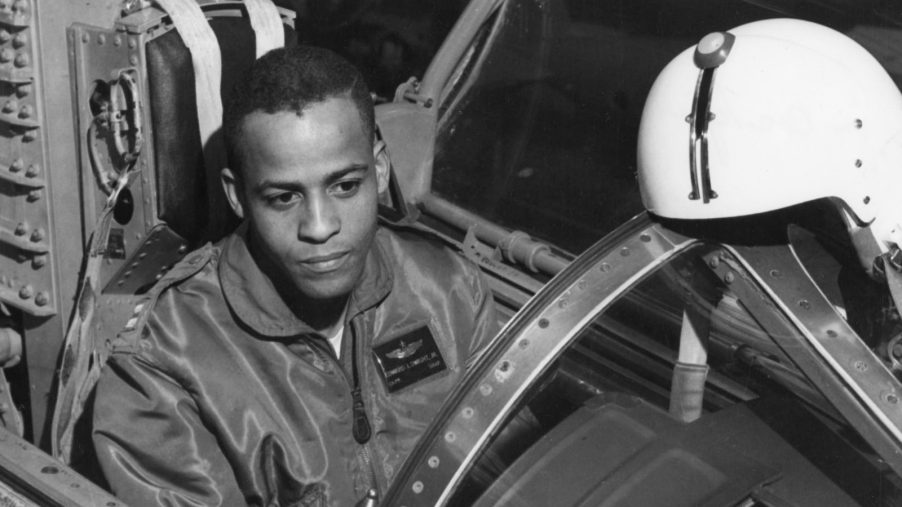 Black and white photo of test pilot Ed Dwight sitting in the cockpit of a plane