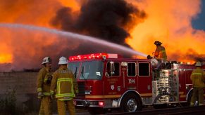 A crew uses a fire truck and its water capacity to fight a blaze.