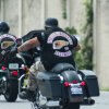 Two motorcyclists with Hell's Angels club patches ride on the interstate.