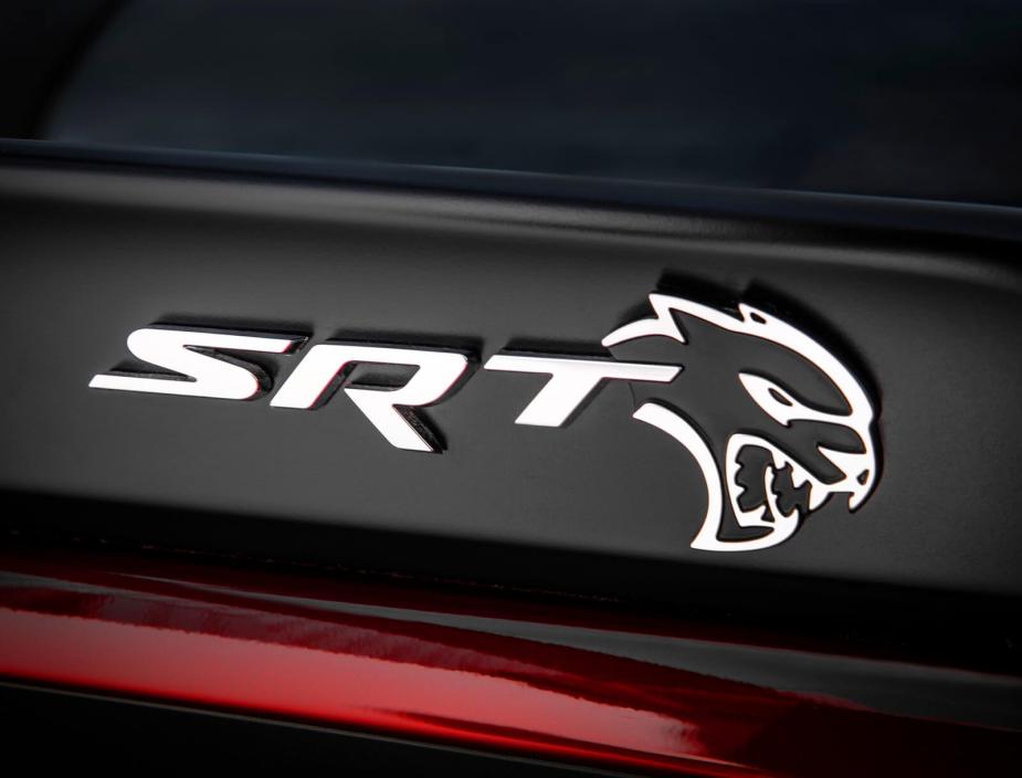 An SRT Hellcat badge on a Dodge performance car.