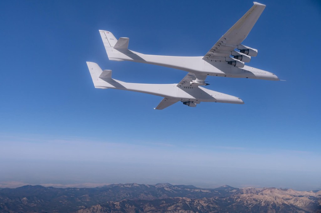 A Stratolaunch Roc, the biggest operating plane in the world, soars through the air.