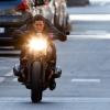 Tom Cruise rides a BMW R nineT Scrambler motorcycle on the movie set for "Mission Impossible: Fallout."