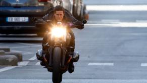 Tom Cruise rides a BMW R nineT Scrambler motorcycle on the movie set for "Mission Impossible: Fallout."