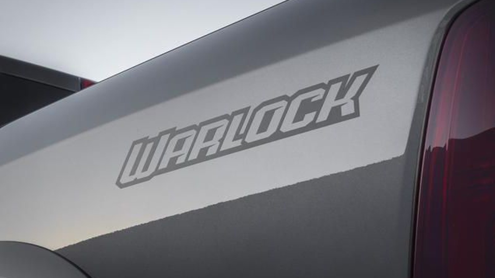 Warlock Badge from the side of a Ram 1500 pickup truck.