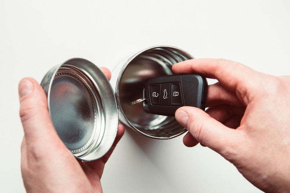 Wireless car key fob stored in a metal tin to prevent a relay attack auto theft.
