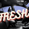 A black leather car interior shown in high contrast blue background word "FRESH!" overlaying in fluorescent font
