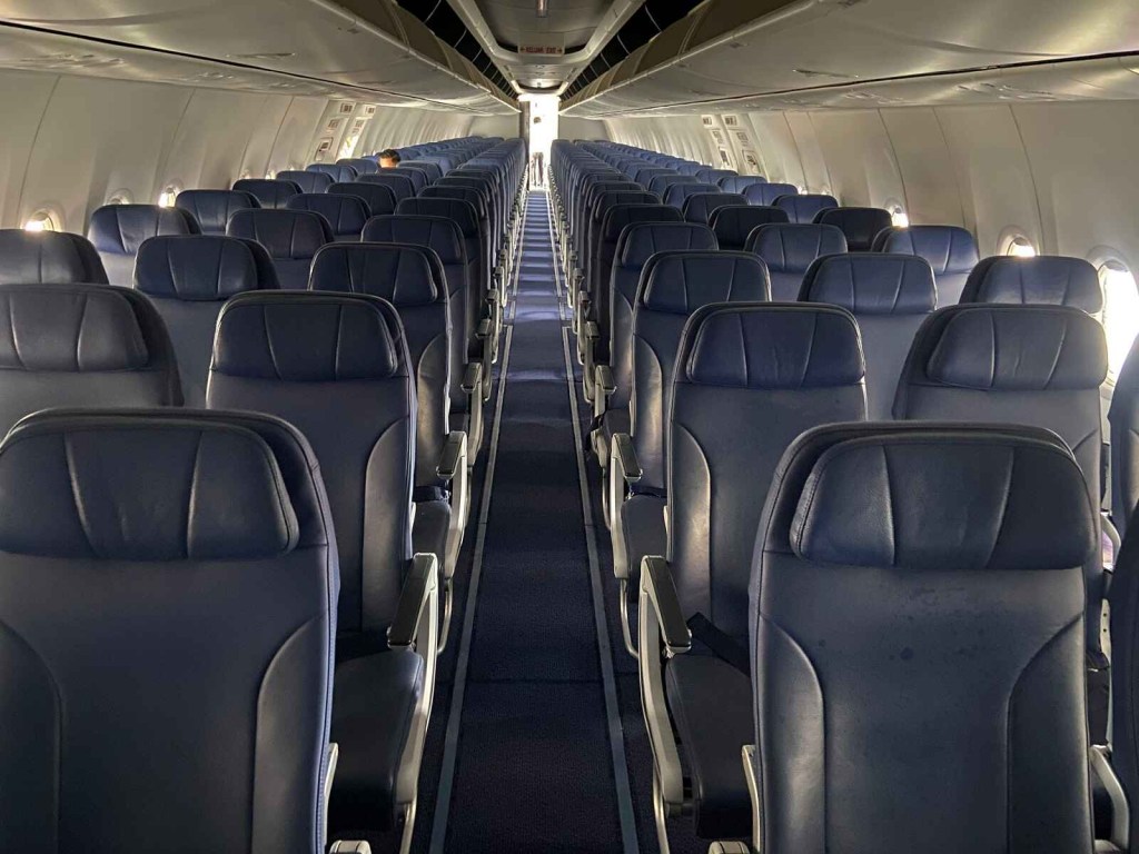 Airline cabin seating with blue seats