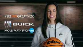 Professional basketball player Caitlin Clark shown holding a basketball with long dark hair and white Nike hoodie for Buick's "See Her Greatness" campaign in 2023