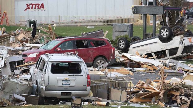 Three SUVs are shown heavily damaged from a tornado in Indiana in 2024, a white SUV is flipped over