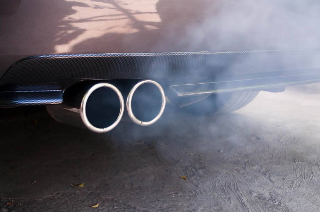 A dual car exhaust with smoke