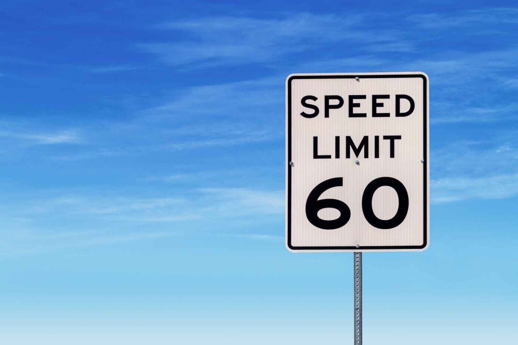 A speed limit 60 sign on a blue cloudy background