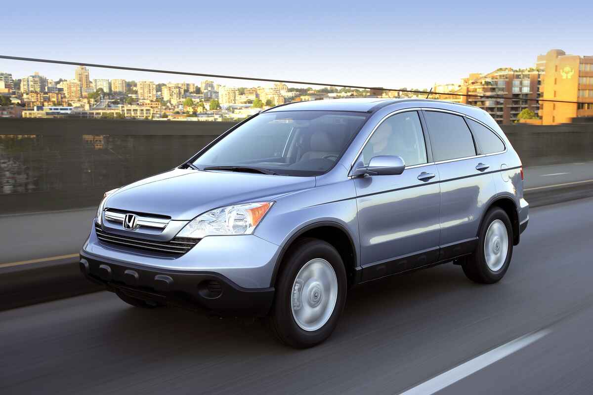 A blue 2008 Honda CR-V driving on a city freeway the car is part of a rear frame recall released in 2023