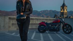 A rider walks away from a 2024 Harley-Davidson Street Bob 114 cruiser motorcycle.