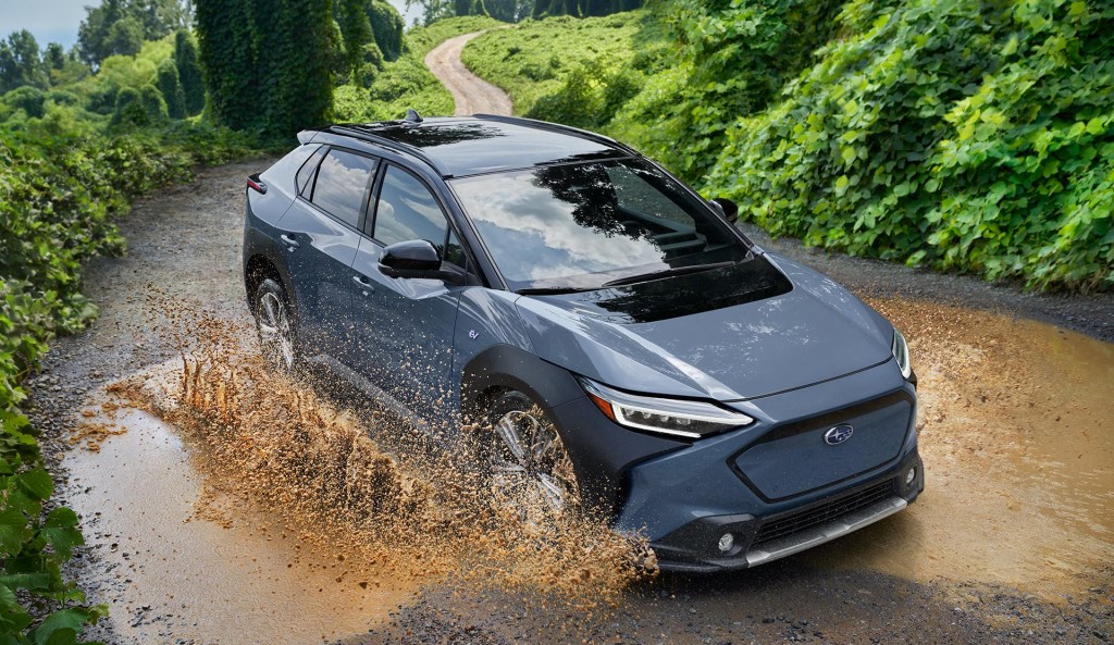 The 2024 Subaru Solterra splashing through a mud puddle