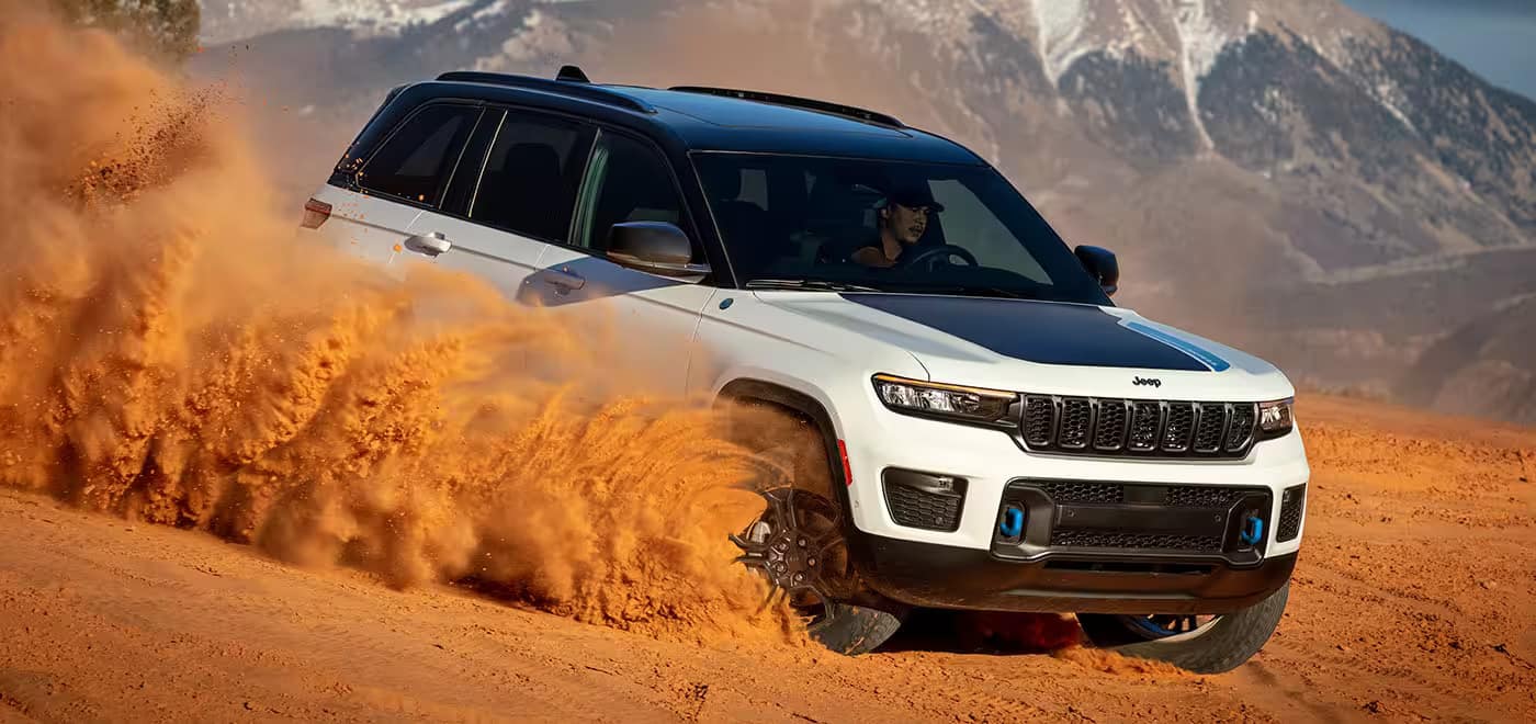 The 2024 Jeep Grand Cherokee kicking up sand