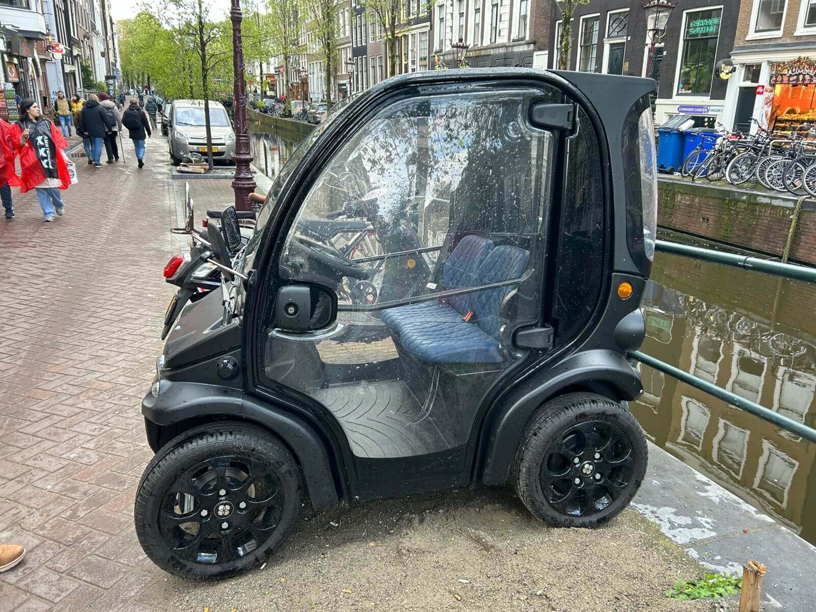 A microcar next to the canals in Amsterdam.
