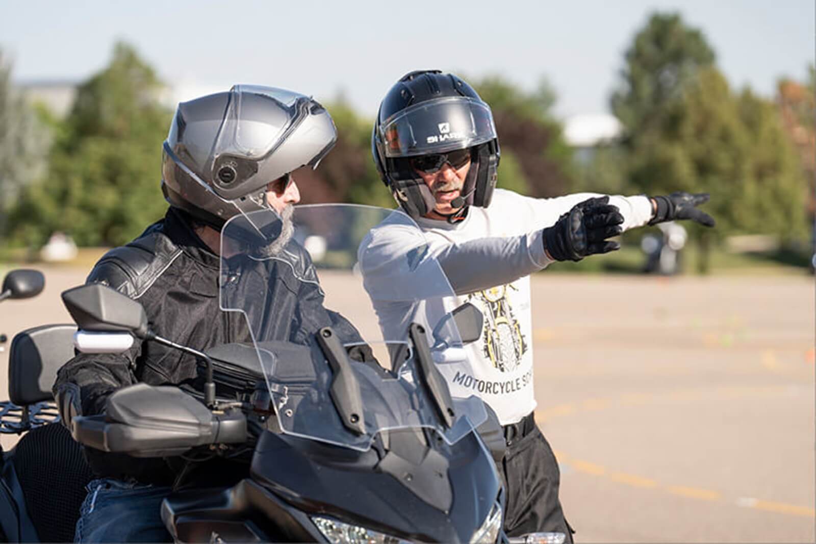An instructor talks to a student at an MSF Basic RiderCourse. 