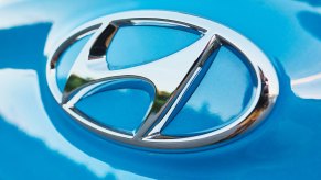 The chrome "H" logo on a blue Hyundai's hood.