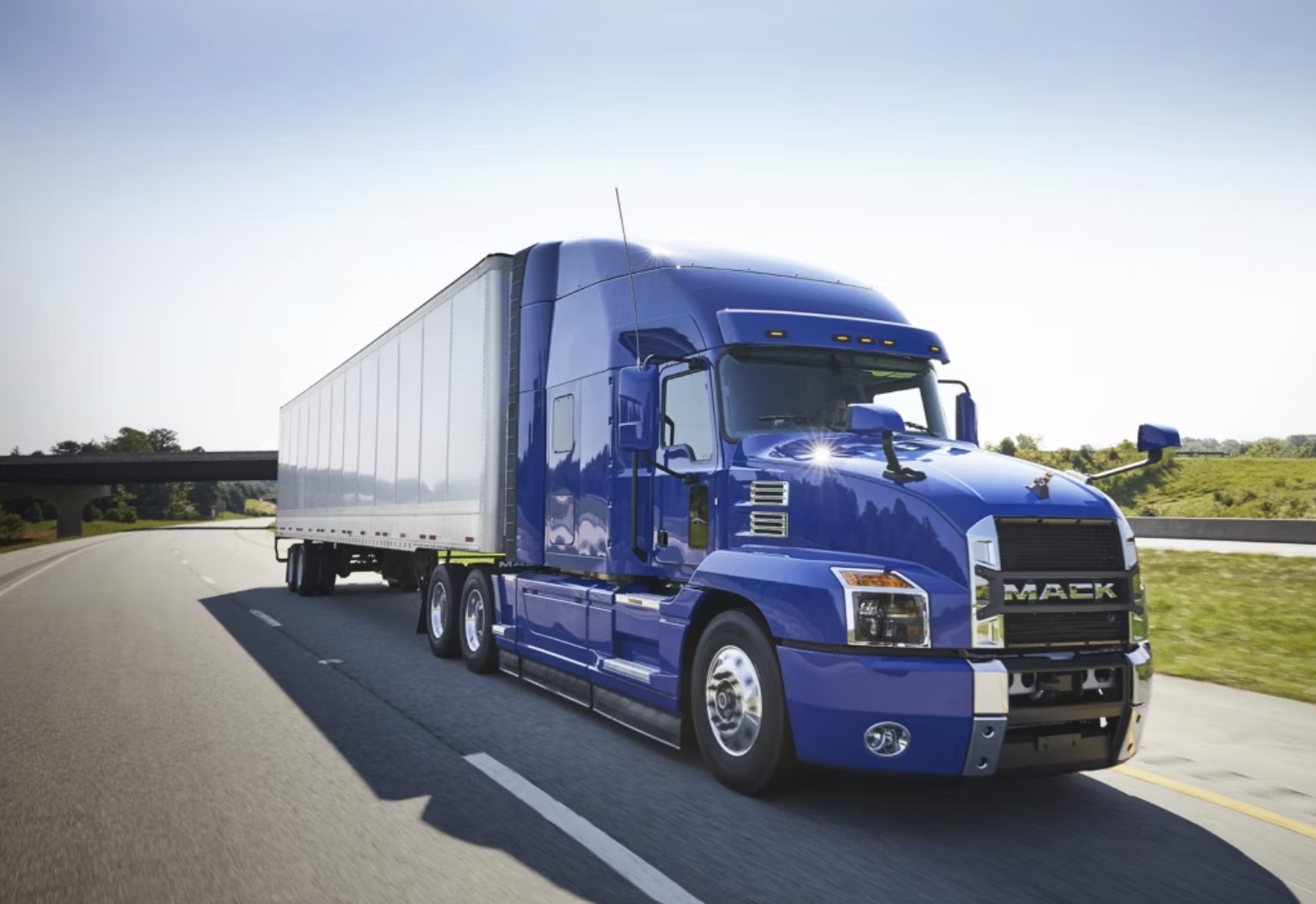 A blue Mack Anthem on the road 