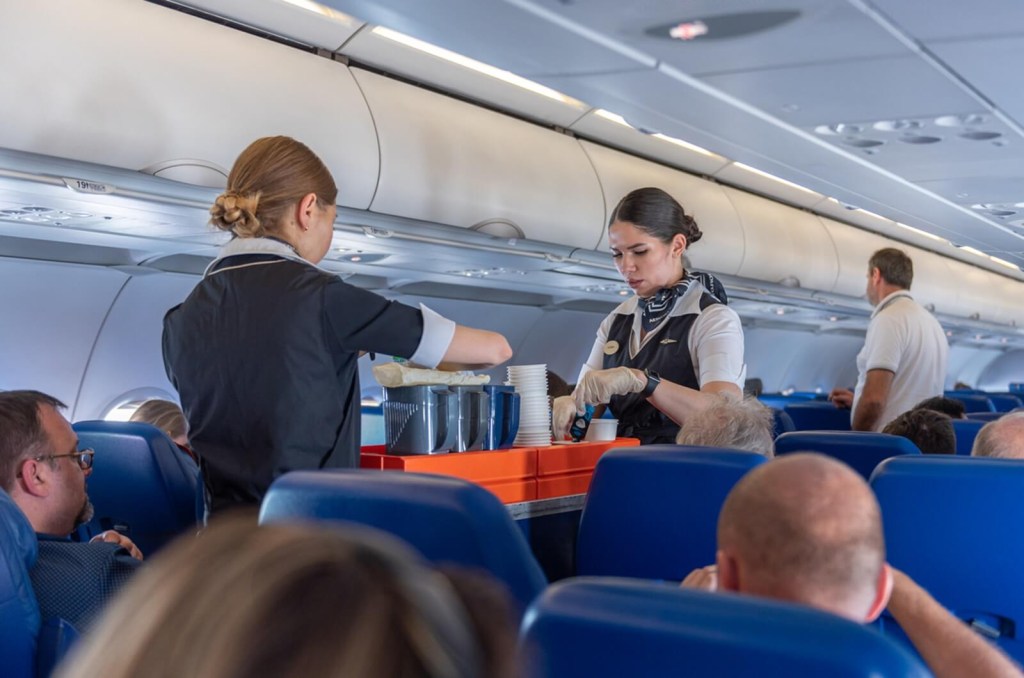 A set of flight attendants, dictated by how many passengers are on the flight, serve passengers.