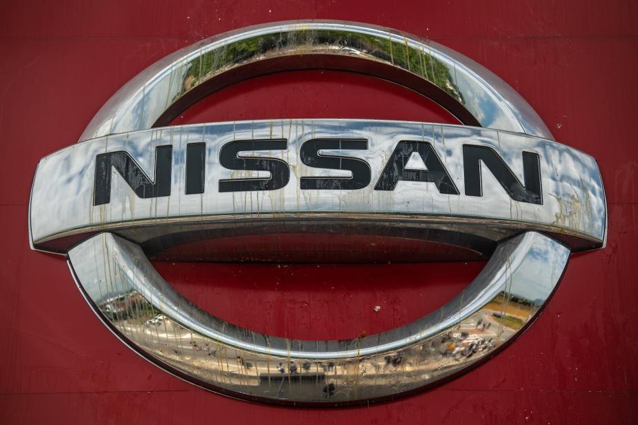Silver Nissan logo on a red truck.