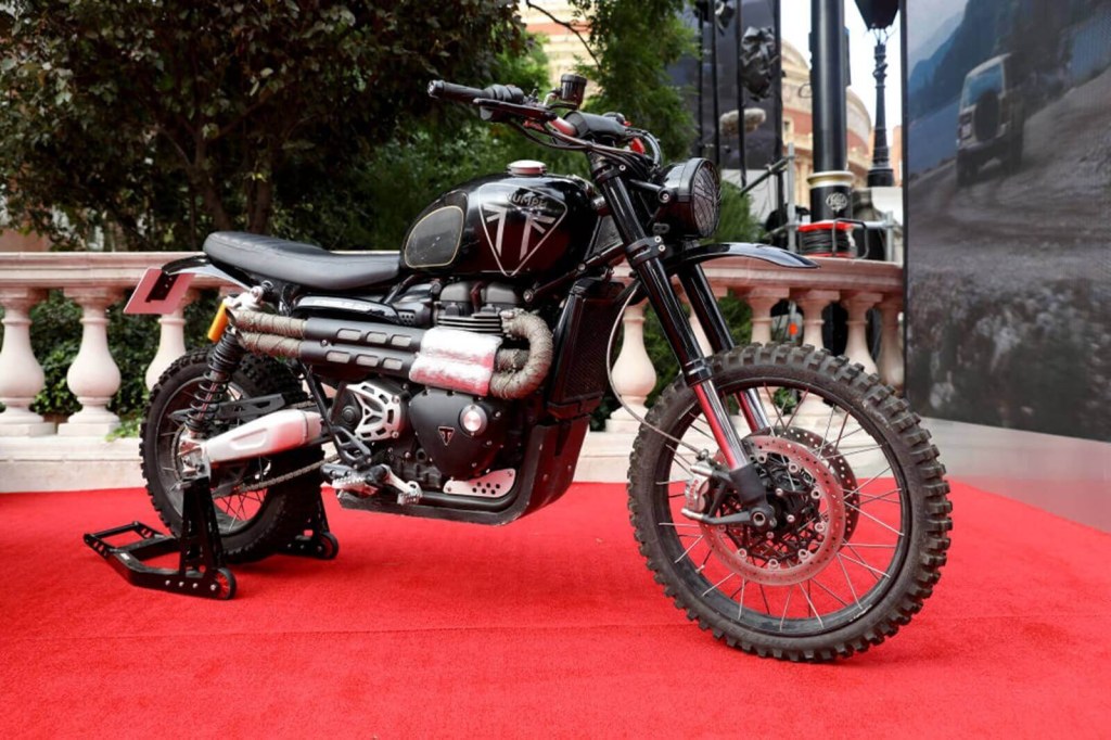 The latest of the James Bond motorcycles, a Triumph Scrambler 1200 sits on the red carpet at an event.