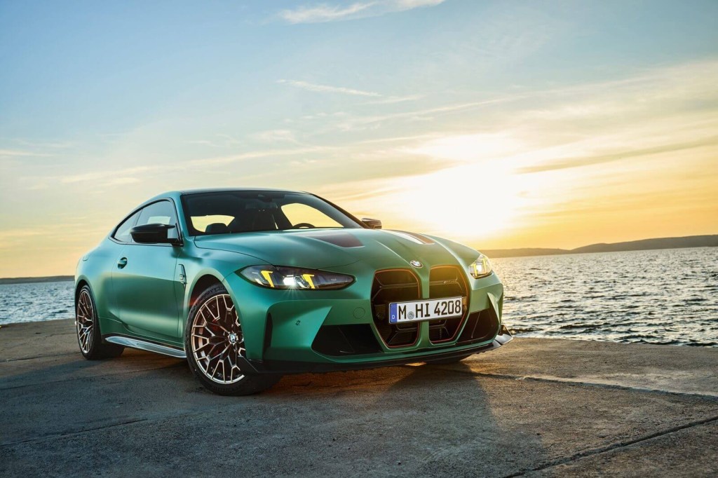 The new 2025 BMW M4 CS shows off its front-end styling next to a sunrise.